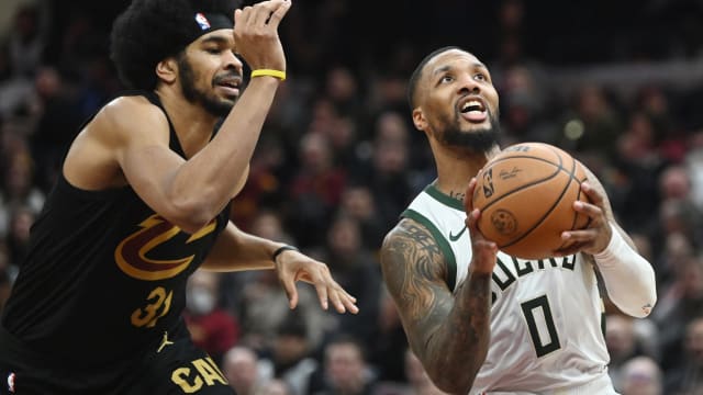 Milwaukee Bucks guard Damian Lillard (0) drives to the basket against Cleveland Cavaliers center Jarrett Allen (31) 